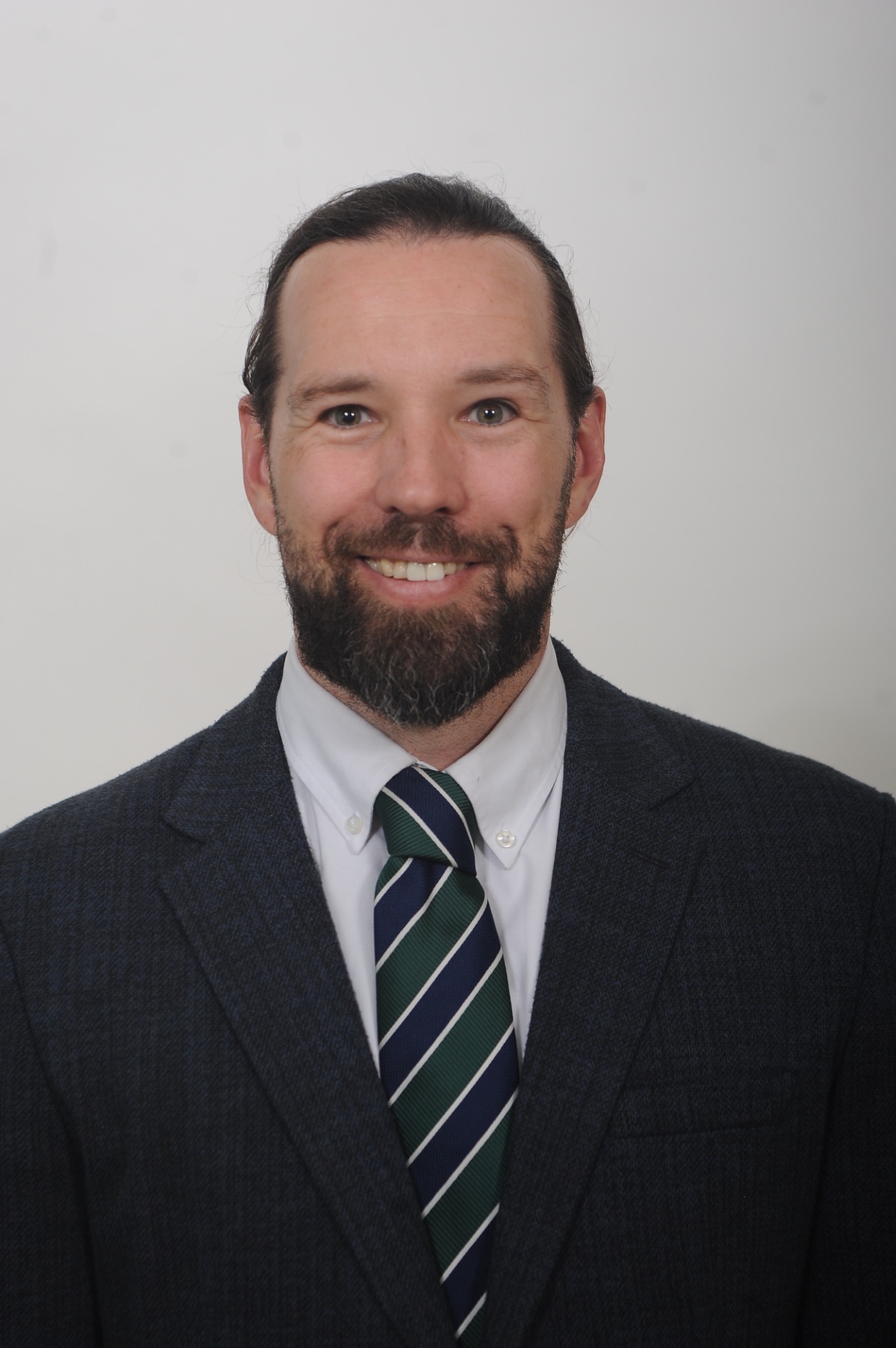 Trevor Hunt smiling in a suit and tie